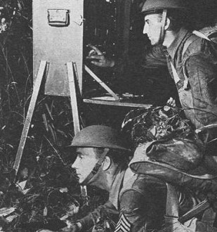 Signal Corps men in combat operate a portable field transmitter - RF Cafe