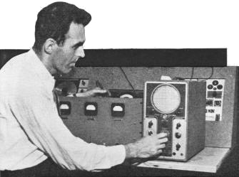 Radio technician applying the oscilloscope in checking transmitter - RF Cafe